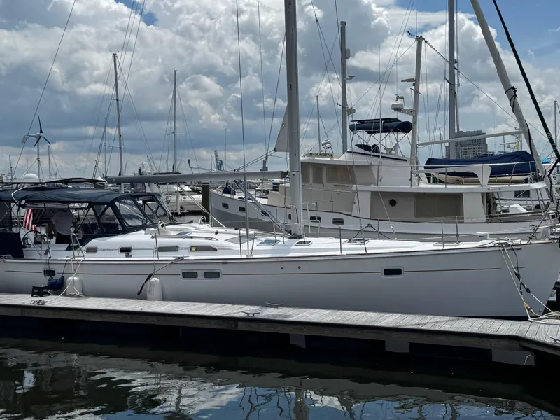 Slide: The Image of 2005 Beneteau Oceanis Clipper 473 sailboat docked at marina under cloudy sky. - 5