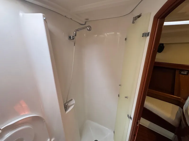 Slide: The Image of Shower area in 2005 Beneteau Oceanis Clipper 473 yacht, featuring sleek white interior. - 50