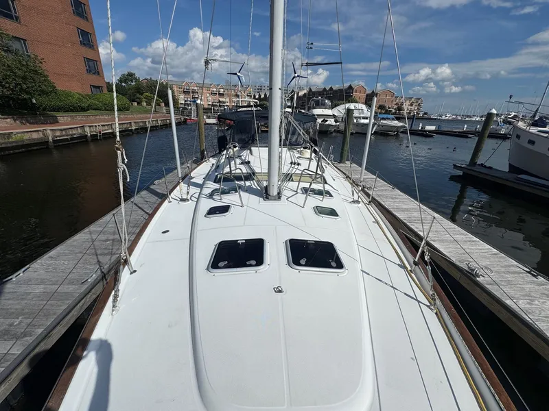 Slide: The Image of 2005 Beneteau Oceanis Clipper 473 docked at marina under blue sky. - 8