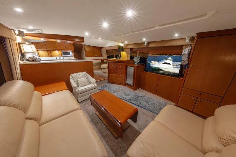 Slide: The Image of Luxurious interior of 2004 Ocean Yachts 57 Convertible with leather seating and wooden cabinetry. - 13