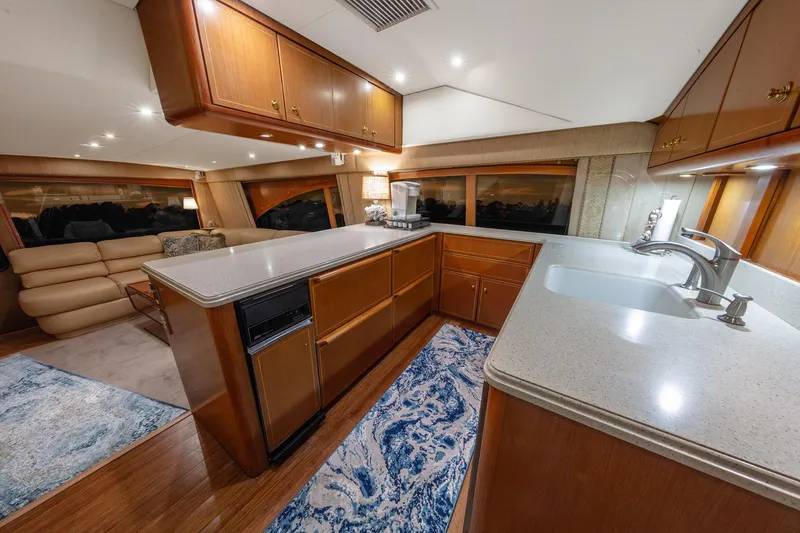 Slide: The Image of Luxurious interior of 2004 Ocean Yachts 57 Convertible with modern kitchen and cozy seating area. - 18