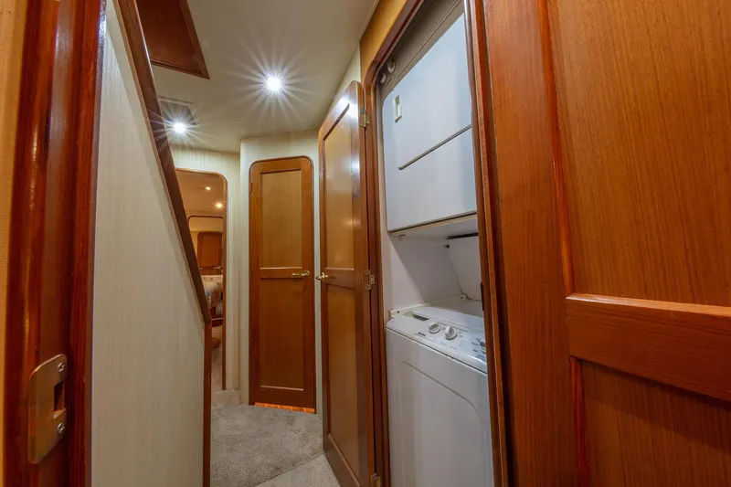 Slide: The Image of Hallway with laundry area in 2004 Ocean Yachts 57 Convertible boat. - 26