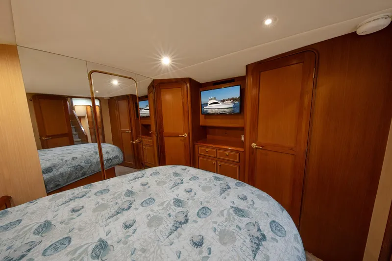 Slide: The Image of Luxurious bedroom interior of 2004 Ocean Yachts 57 Convertible with wood paneling and TV. - 28