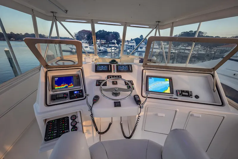 Slide: The Image of Helm of 2004 Ocean Yachts 57 Convertible with advanced navigation systems and scenic marina view. - 32