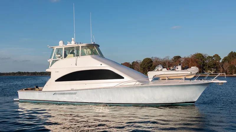 Slide: The Image of 2004 Ocean Yachts 57 Convertible cruising on a calm lake under a clear blue sky. - 4