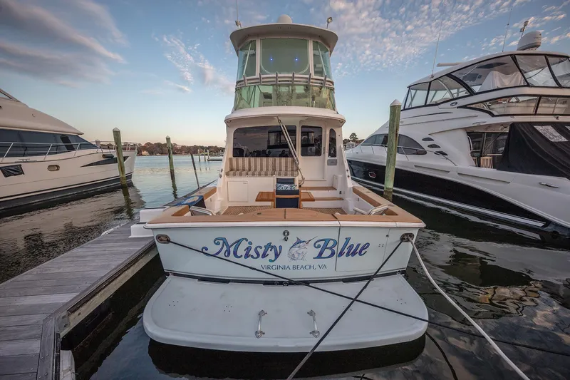 Slide: The Image of 2004 Ocean Yachts 57 Convertible docked, named "Misty Blue," in Virginia Beach marina. - 40