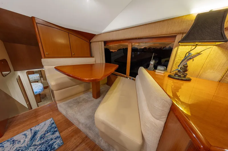 Slide: The Image of Luxurious interior of 2004 Ocean Yachts 57 Convertible with elegant wood finishes and cozy seating. - 19