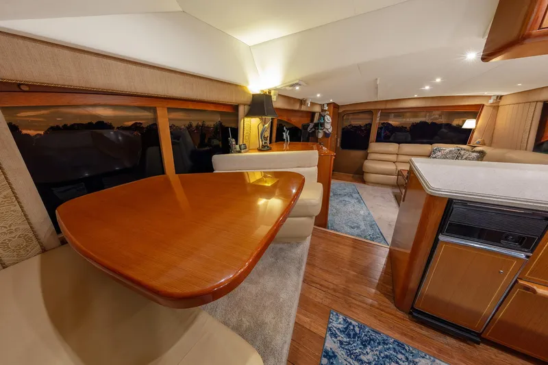 Slide: The Image of Luxurious interior of 2004 Ocean Yachts 57 Convertible with elegant wood finishes and cozy seating. - 20