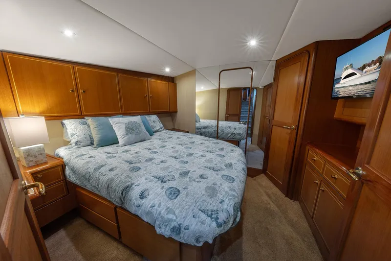 Slide: The Image of Luxurious bedroom interior of 2004 Ocean Yachts 57 Convertible with elegant wood cabinetry. - 27