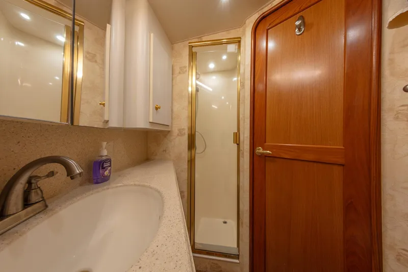 Slide: The Image of Luxurious bathroom in 2004 Ocean Yachts 57 Convertible, featuring a shower and elegant wood finishes. - 29