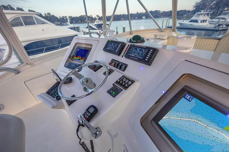 Slide: The Image of Helm of 2004 Ocean Yachts 57 Convertible with navigation screens and controls. - 34