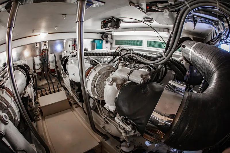 Slide: The Image of Engine room of a 2004 Ocean Yachts 57 Convertible, showcasing complex machinery and wiring. - 48