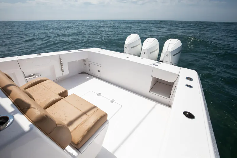 Slide: The Image of 2025 Bahama 37 Super Center Console boat with triple Mercury engines on open sea. - 11