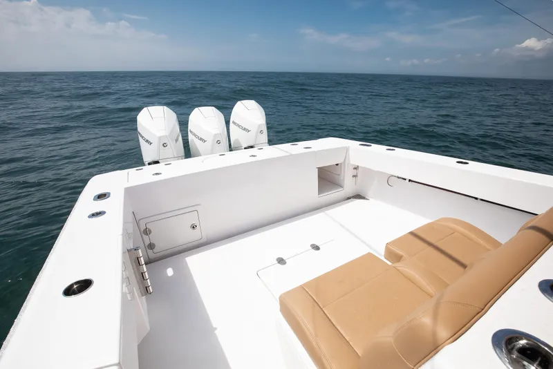Slide: The Image of 2025 Bahama 37 Super Center Console boat with triple Mercury engines on open sea. - 12