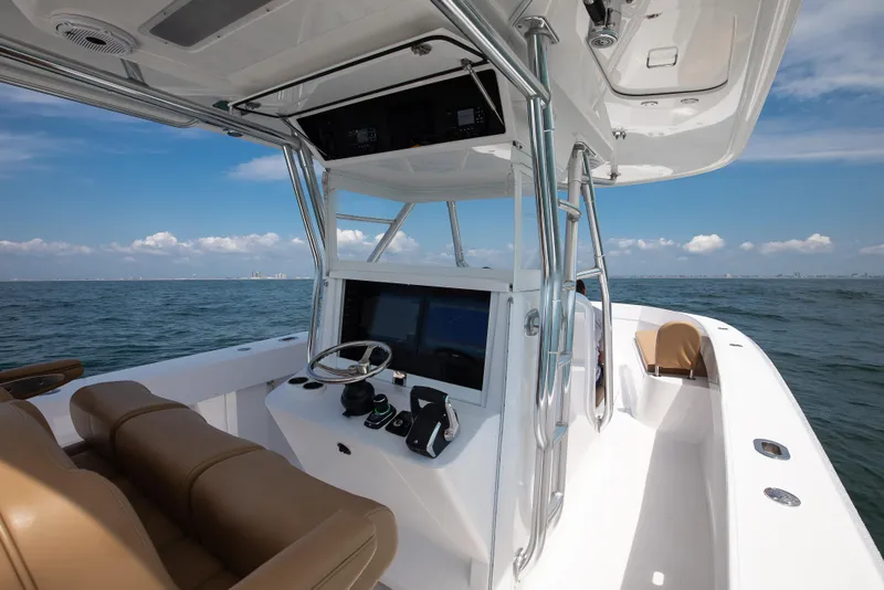 Slide: The Image of 2025 Bahama 37 Super Center Console boat on open water, featuring sleek design and modern controls. - 17