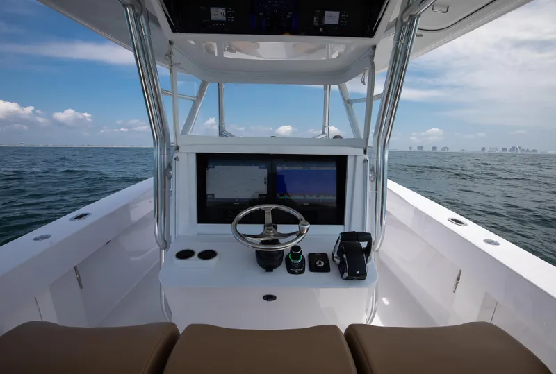 Slide: The Image of 2025 Bahama 37 Super Center Console boat dashboard with ocean view. - 14