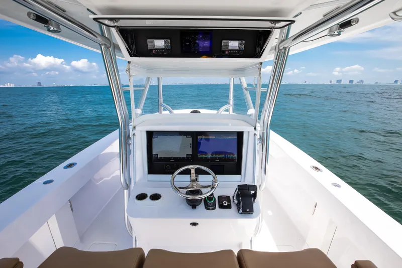 Slide: The Image of 2025 Bahama 37 Super Center Console boat on open water, featuring advanced navigation systems. - 15