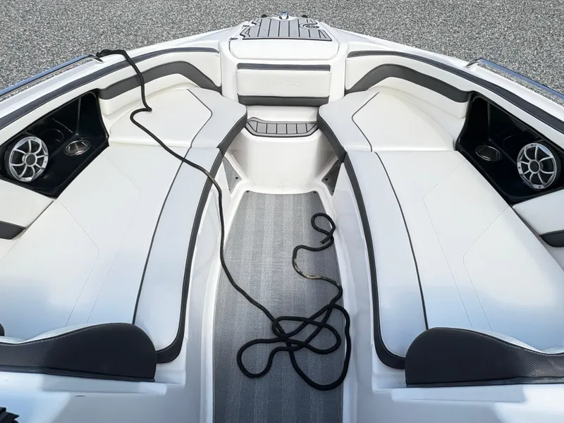 Slide: The Image of 2019 Yamaha Boats 242 Limited E-Series interior with white seating and speakers. - 13