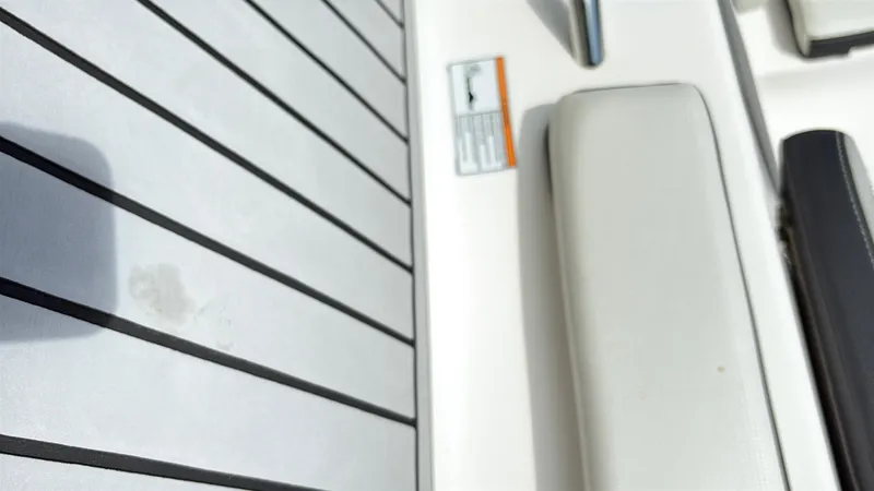 Slide: The Image of 2019 Yamaha Boats 242 Limited E-Series interior with cushioned seating and sleek flooring. - 16