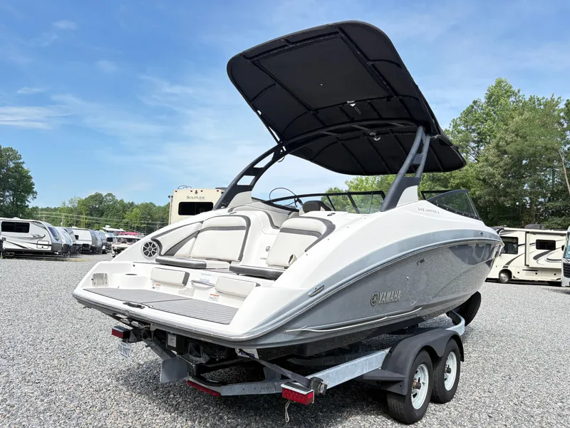Slide: The Image of 2019 Yamaha Boats 242 Limited E-Series on trailer, parked outdoors. - 3