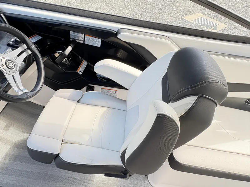Slide: The Image of 2019 Yamaha Boats 242 Limited E-Series cockpit with steering wheel and comfortable seating. - 6