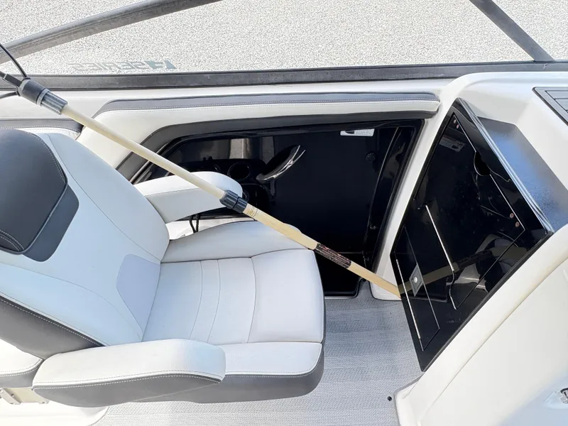 Slide: The Image of 2019 Yamaha Boats 242 Limited E-Series interior with seat and storage compartment. - 8