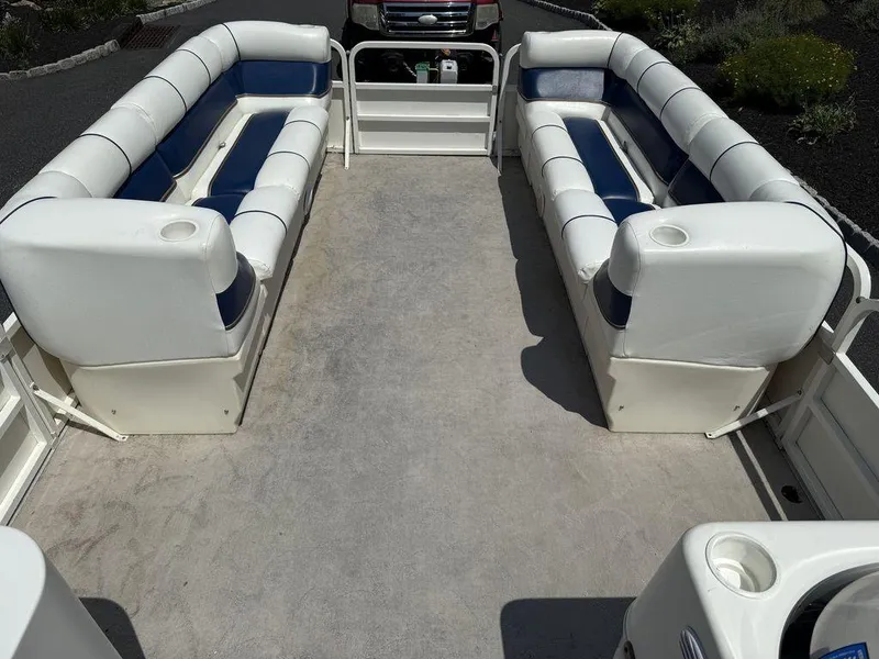 Slide: The Image of 2006 Bentley Pontoons 240 CRUISE interior with white and blue seating, spacious layout. - 4