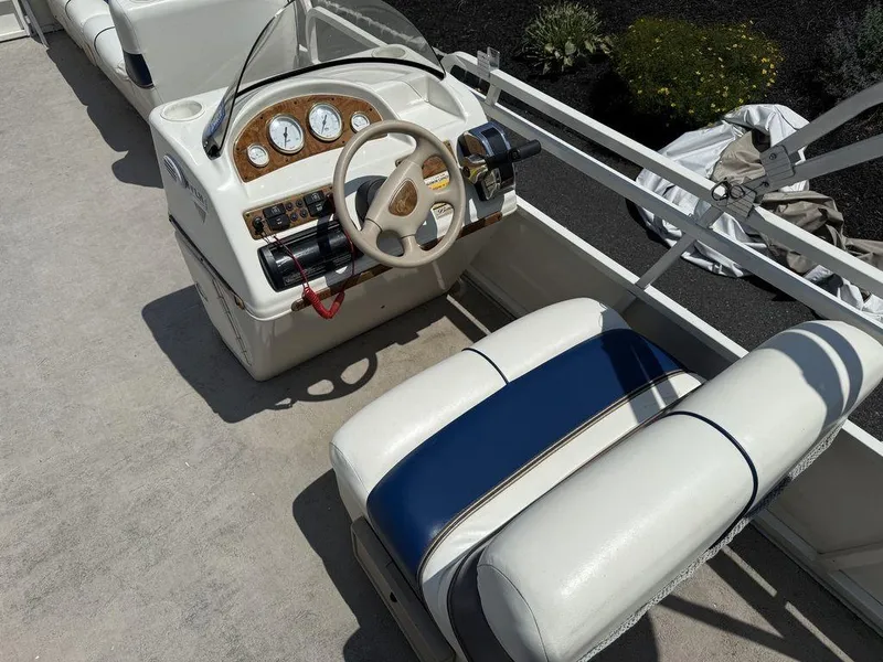 Slide: The Image of 2006 Bentley Pontoons 240 CRUISE helm with steering wheel and gauges. - 5