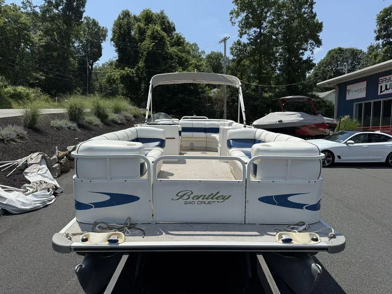 Slide: The Image of 2006 Bentley Pontoons 240 CRUISE boat with white seating, parked outdoors. - 7
