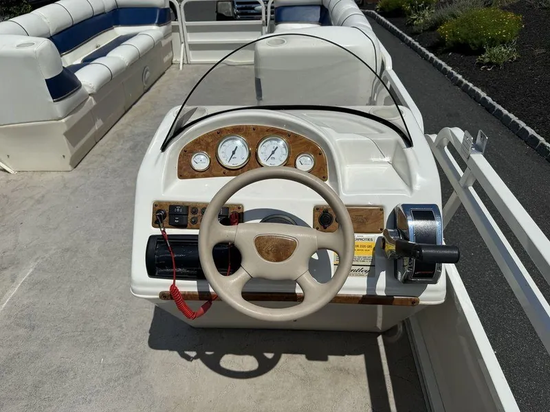 Slide: The Image of 2006 Bentley Pontoons 240 CRUISE dashboard with steering wheel and gauges. - 8
