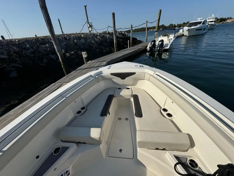 Slide: The Image of 2023 Sailfish 312 CC boat docked, showcasing spacious seating and sleek design. - 13