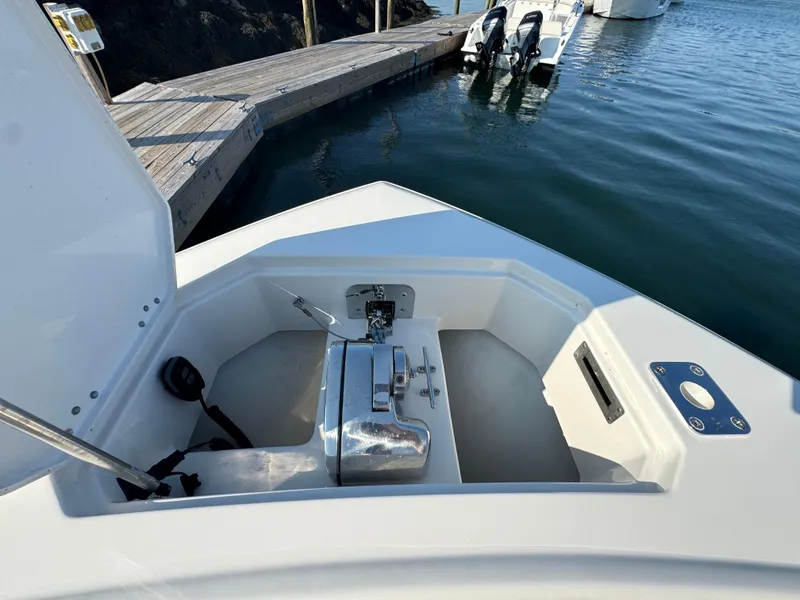 Slide: The Image of 2023 Sailfish 312 CC boat anchor compartment near dock. - 17