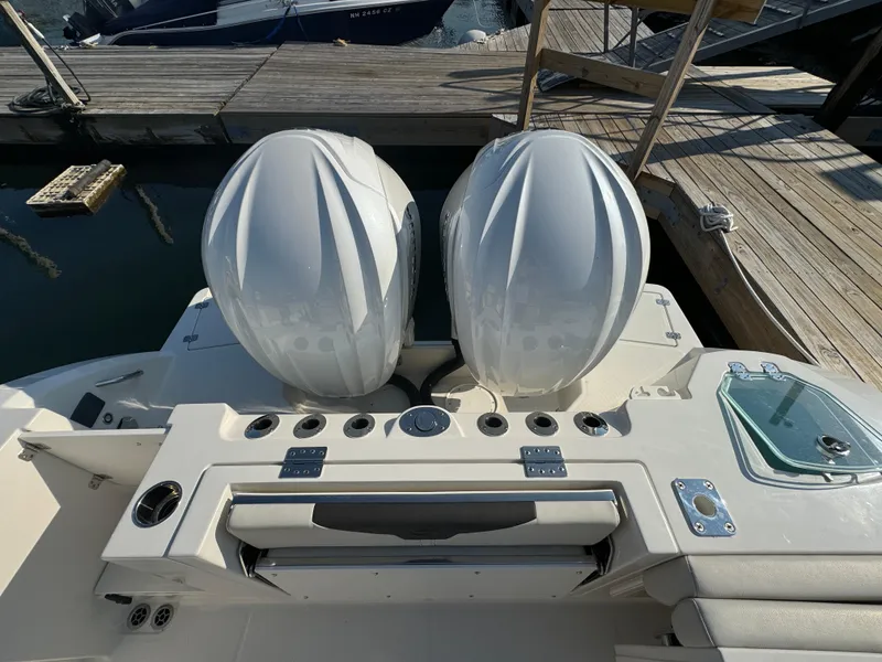 Slide: The Image of 2023 Sailfish 312 CC boat with dual engines docked at a marina. - 3