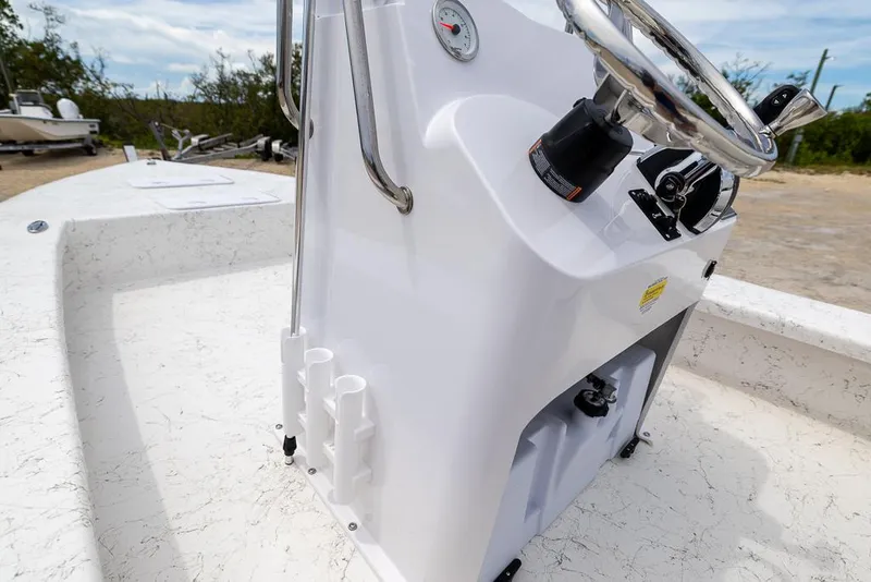 Slide: The Image of 2026 Coastal Skiff 231 boat console with steering wheel and rod holders. - 19