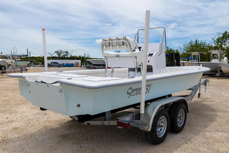 Slide: The Image of 2026 Coastal Skiff 231 boat on trailer in outdoor setting. - 4