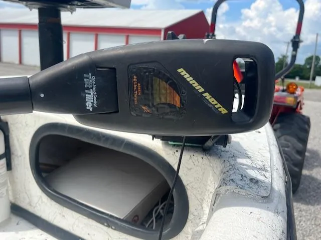 Slide: The Image of Minn Kota trolling motor on 2000 Carolina Skiff J1450 boat, outdoor setting. - 4