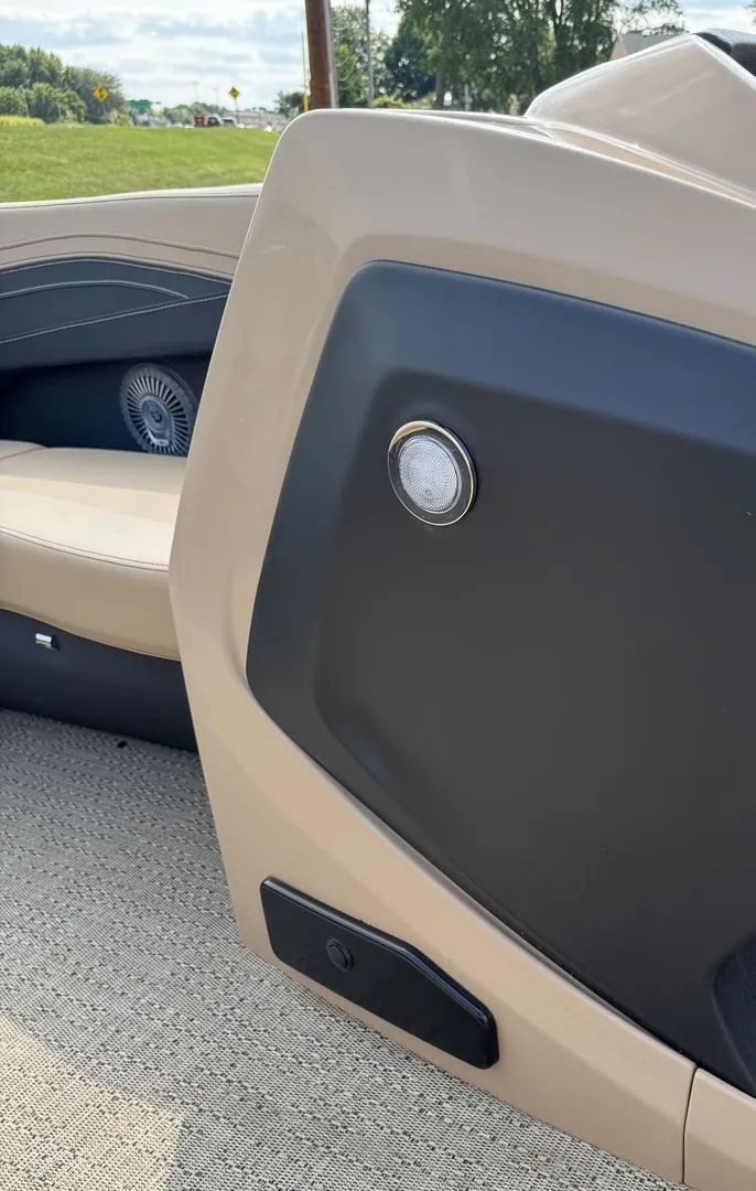Slide: The Image of Close-up of a section of the Barletta Cabrio 24 UE boat, featuring a speaker and cushioned seating. - 19