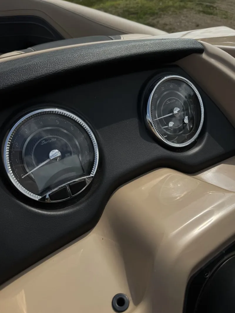 Slide: The Image of Close-up of two round gauges on a boat panel, surrounded by beige material. - 14