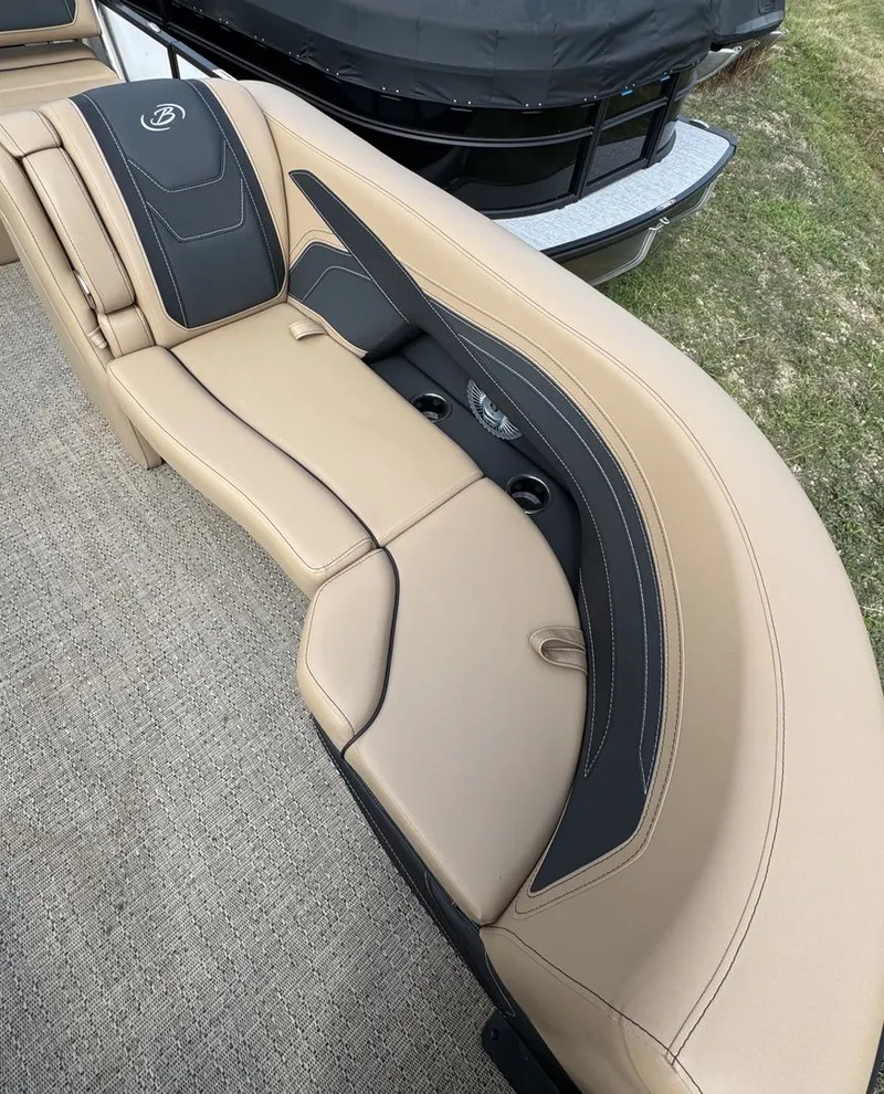 Slide: The Image of The image shows a luxurious beige upholstered seat on a boat, with black accents and cup holders. - 23
