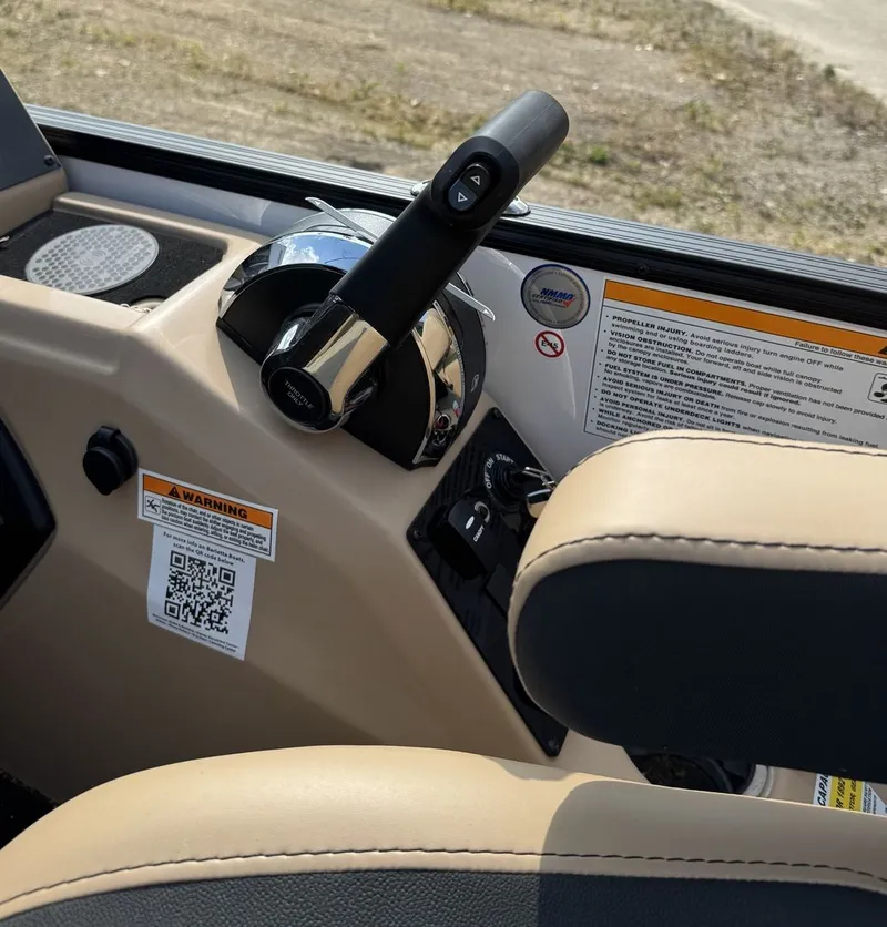 Slide: The Image of Close-up of a Barletta Cabrio 24 UE helm with throttle and warning labels. - 17