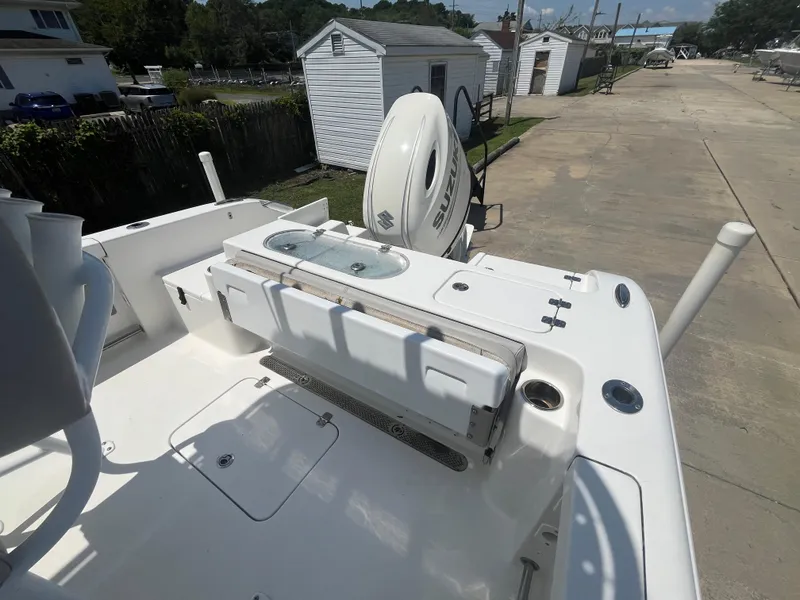 Slide: The Image of 2018 Sea Pro 219 Center Console boat with Suzuki outboard motor, docked on a sunny day. - 12