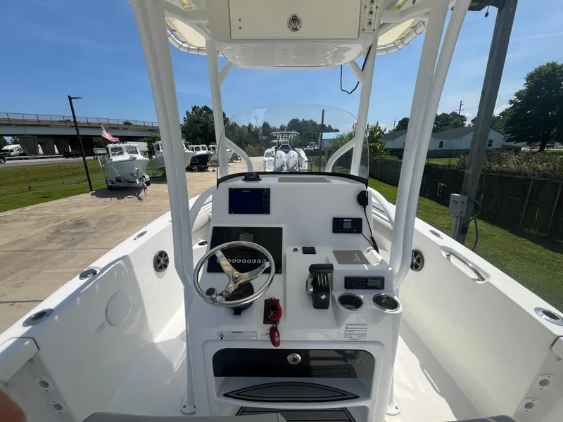 Slide: The Image of 2018 Sea Pro 219 Center Console boat interior with steering wheel and navigation equipment. - 5