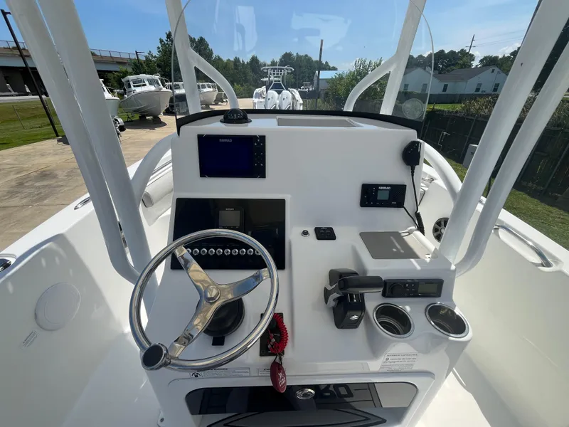 Slide: The Image of 2018 Sea Pro 219 Center Console boat dashboard with steering wheel and navigation equipment. - 6