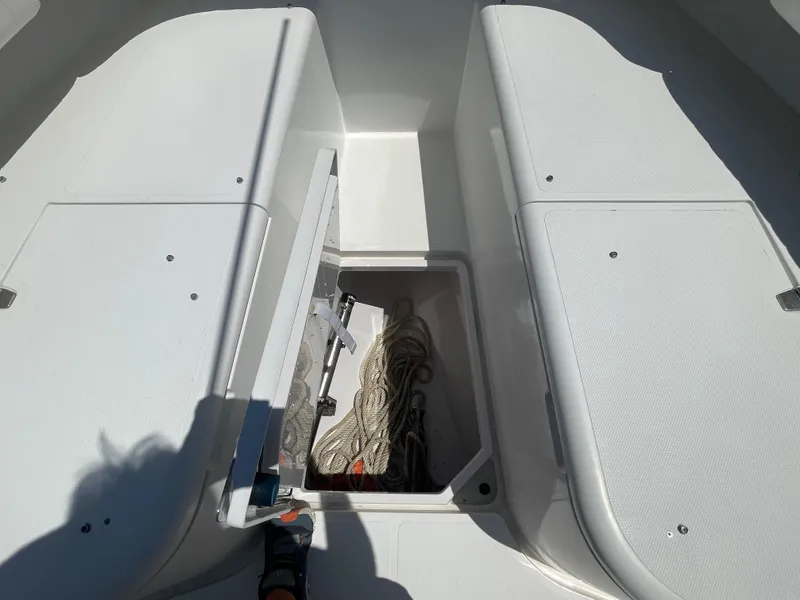 Slide: The Image of Open storage compartment on 2006 Southport 26 Center Console boat, containing ropes. - 10