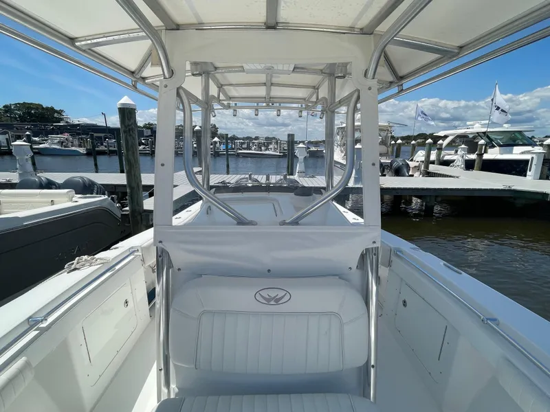 Slide: The Image of 2006 Southport 26 Center Console boat docked at marina under clear blue sky. - 11