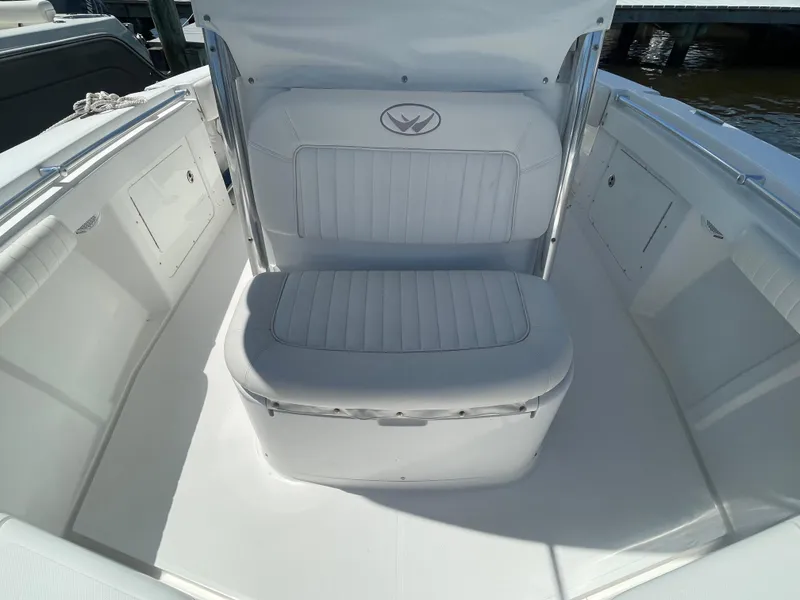 Slide: The Image of 2006 Southport 26 Center Console boat interior with cushioned seating and storage compartments. - 13