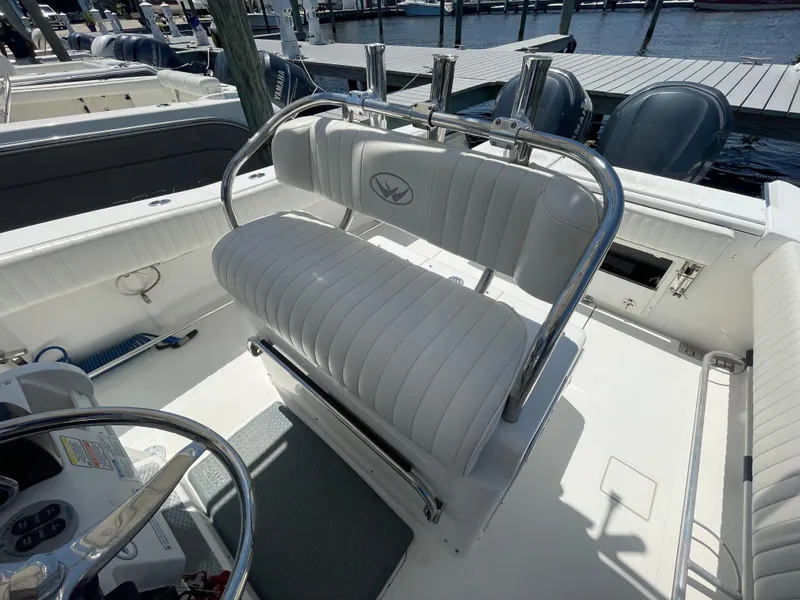 Slide: The Image of 2006 Southport 26 Center Console boat interior with white seating and rod holders. - 17