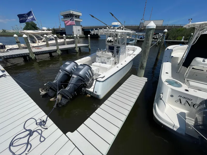 Slide: The Image of 2006 Southport 26 Center Console boat docked with twin Yamaha engines. - 2
