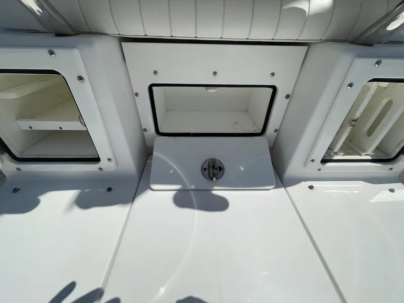 Slide: The Image of 2006 Southport 26 Center Console boat storage compartments and seating area. - 34