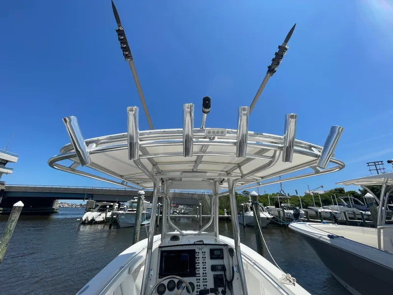 Slide: The Image of 2006 Southport 26 Center Console boat docked, featuring a T-top and rod holders. - 39